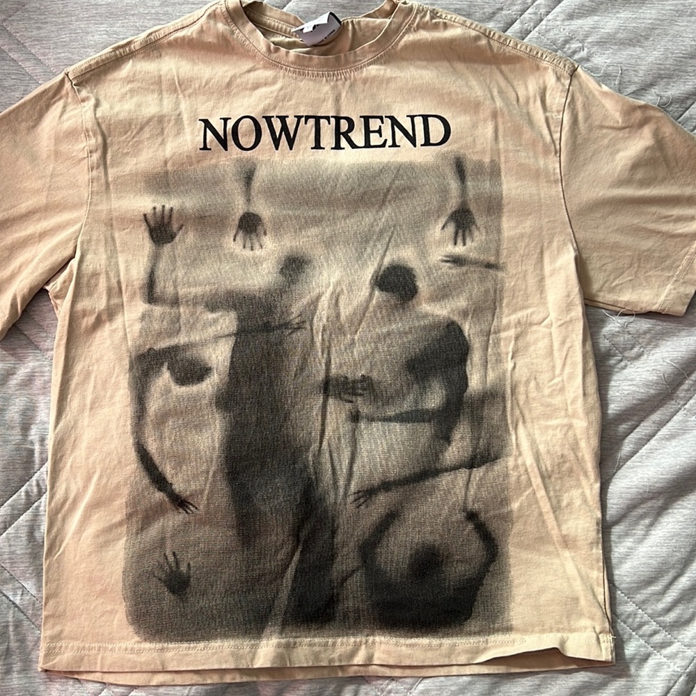 This is a medium now trend shirt with a large printed design on the front.